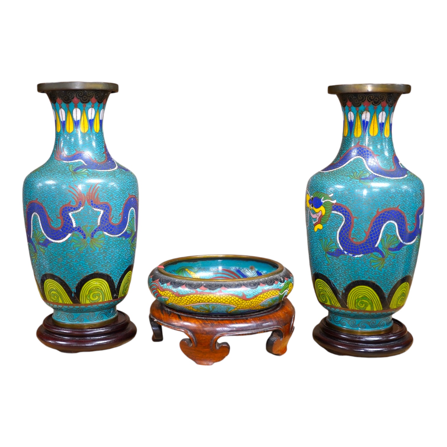 A pair of Chinese cloisonné enamel ‘dragon’ vases on stands and a similar bowl on stand, vases 28.5cm high including stands. Condition - good